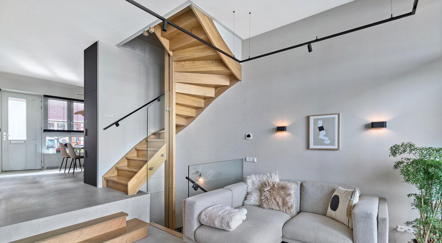 Modern living room with Acosorb acoustic ceiling panels and wooden staircase
